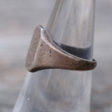 Bronze ring on a glass tube with a blurred background