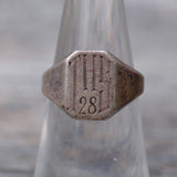 Close-up of a metallic object with engraved numbers on a blurred background